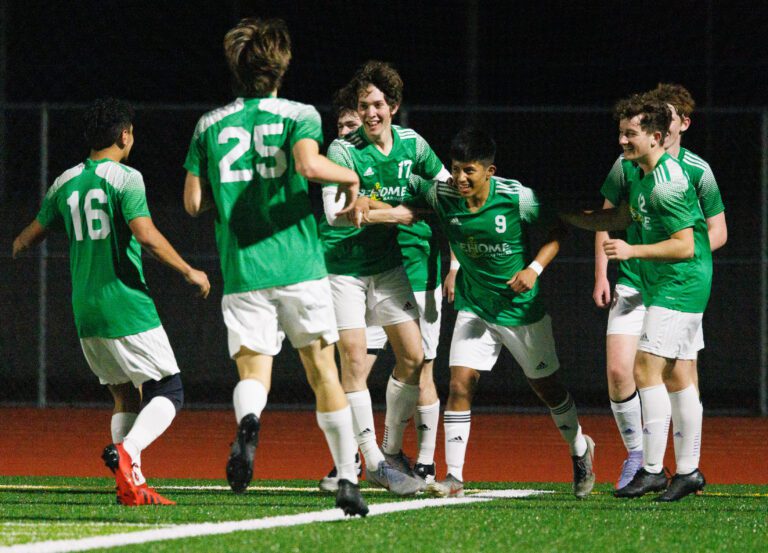 Sehome players surround  teammate Gilberto Andrews (9) after he scores a goal to give the Mariners a 2-1 lead over Bellingham in a boys soccer match on March 18.