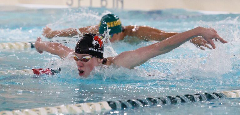 Bellingham's Kason Devaney leads Sehome’s Scotty Li in the 100-yard butterfly as Bellingham took on Sehome at Arne Hanna Aquatic Center on Dec. 15.