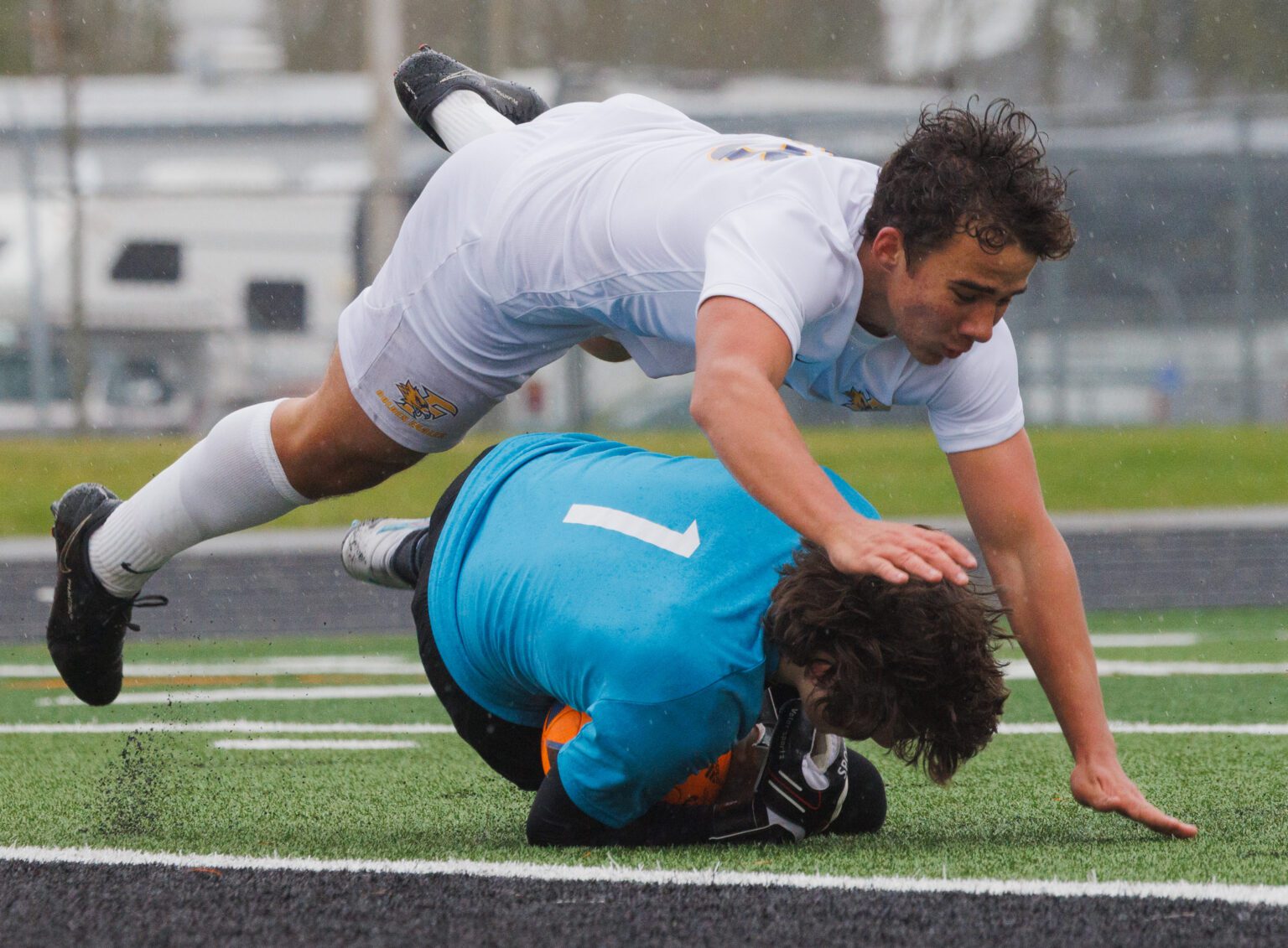 Ferndale’s Ruslan Yelfimov dives over Blaine goalkeeper Kael Evinger April 15 after a shot on goal in the second half in Blaine. The Golden Eagles and Borderites battled to a 0-0 tie.