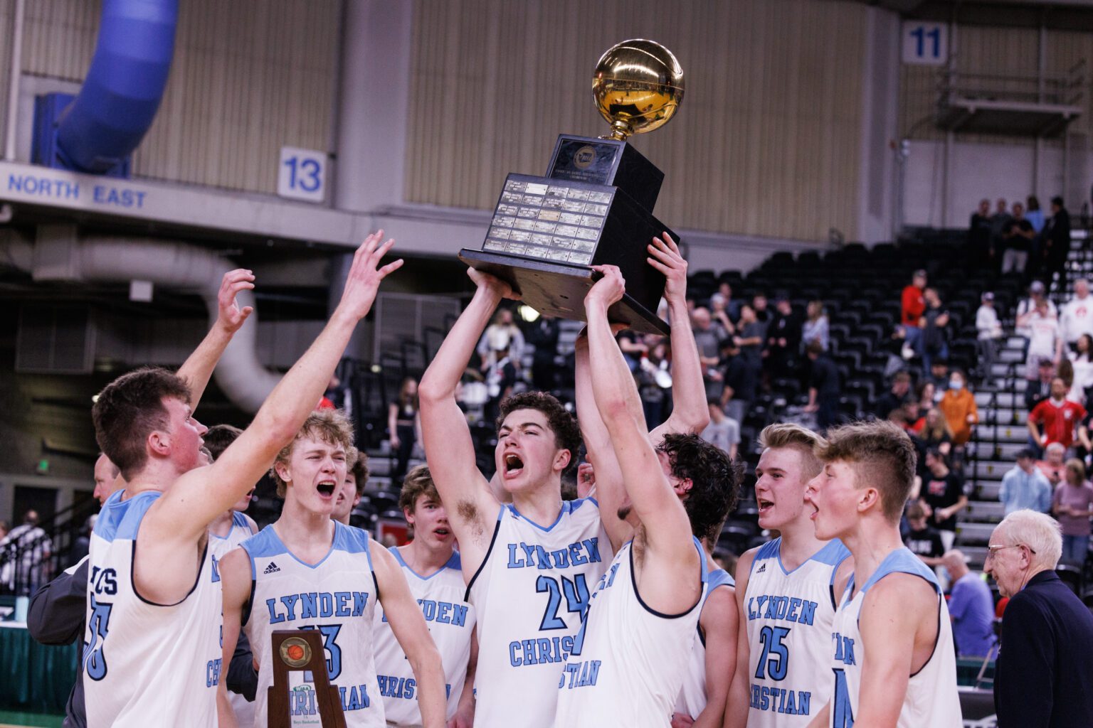 Lynden Christian celebrates with the trophy after the Lyncs beat King's 61-58 in the 1A state championship game at the Yakima Valley SunDome on March 5.