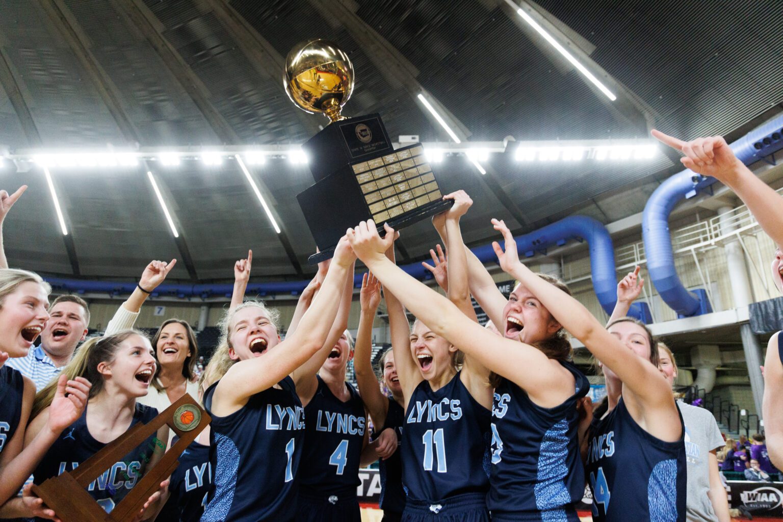 Lynden Christian celebrates after beating Nooksack Valley 57-56 in overtime to win the girls 1A state championship title at the Yakima Valley SunDome on March 5.