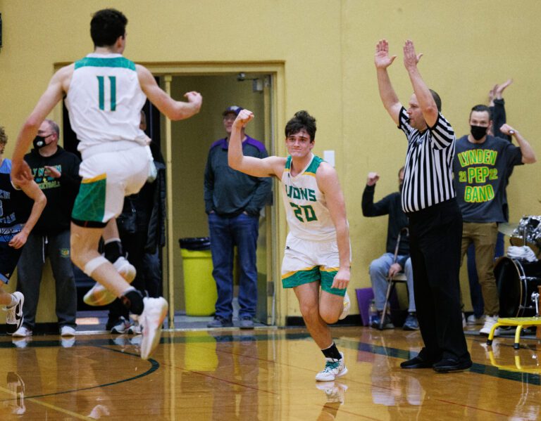 Lynden’s Dawson Adams pumps a fist after scoring what would be the winning three-point shot as teammate Jordan Medcalf leaps in celebration. Lynden beat Lynden Christian 63-60 in a boys basketball game on Jan. 28.
