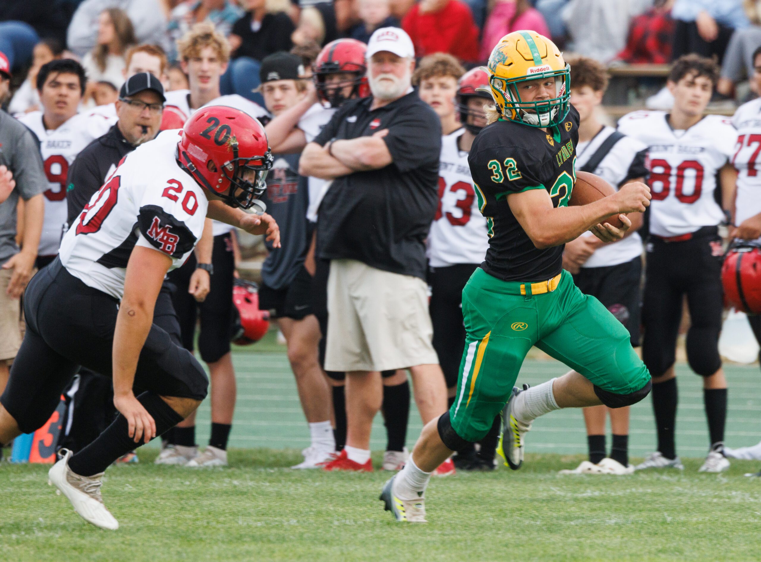 Lynden running back Lane Heeringa runs away from Mount Baker defenders for a touchdown during a football jamboree at Lynden High School on Aug. 26.