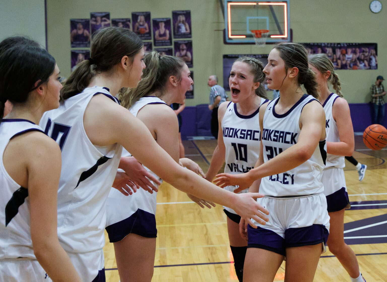 Nooksack Valley's Lainey Kimball (10) celebrates with teammates after NV beat Lynden Christian 66-52 in a 1A title rematch on Jan. 6.