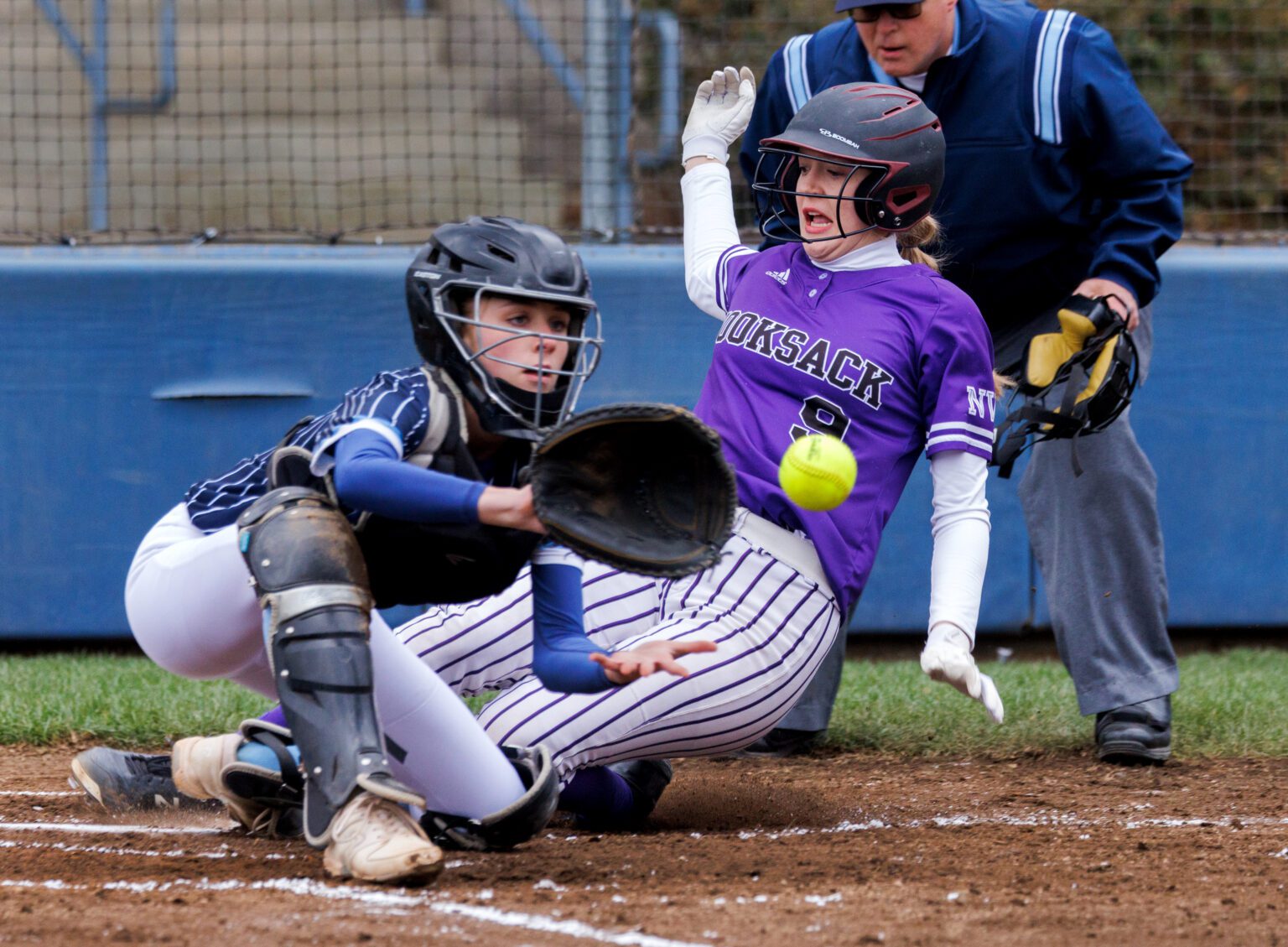 Nooksack Valley’s Lainey Kimball slides into home plate ahead of the throw March 23 as the Pioneers held a 5-0 lead in the third inning against Lynden Christian before the game rained out.