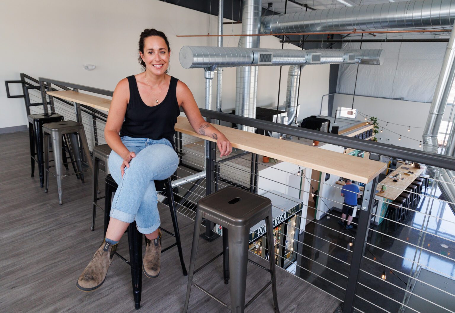 Owner Jessie Polin sits in the mezzanine of Ponderosa Beer + Books on July 8.