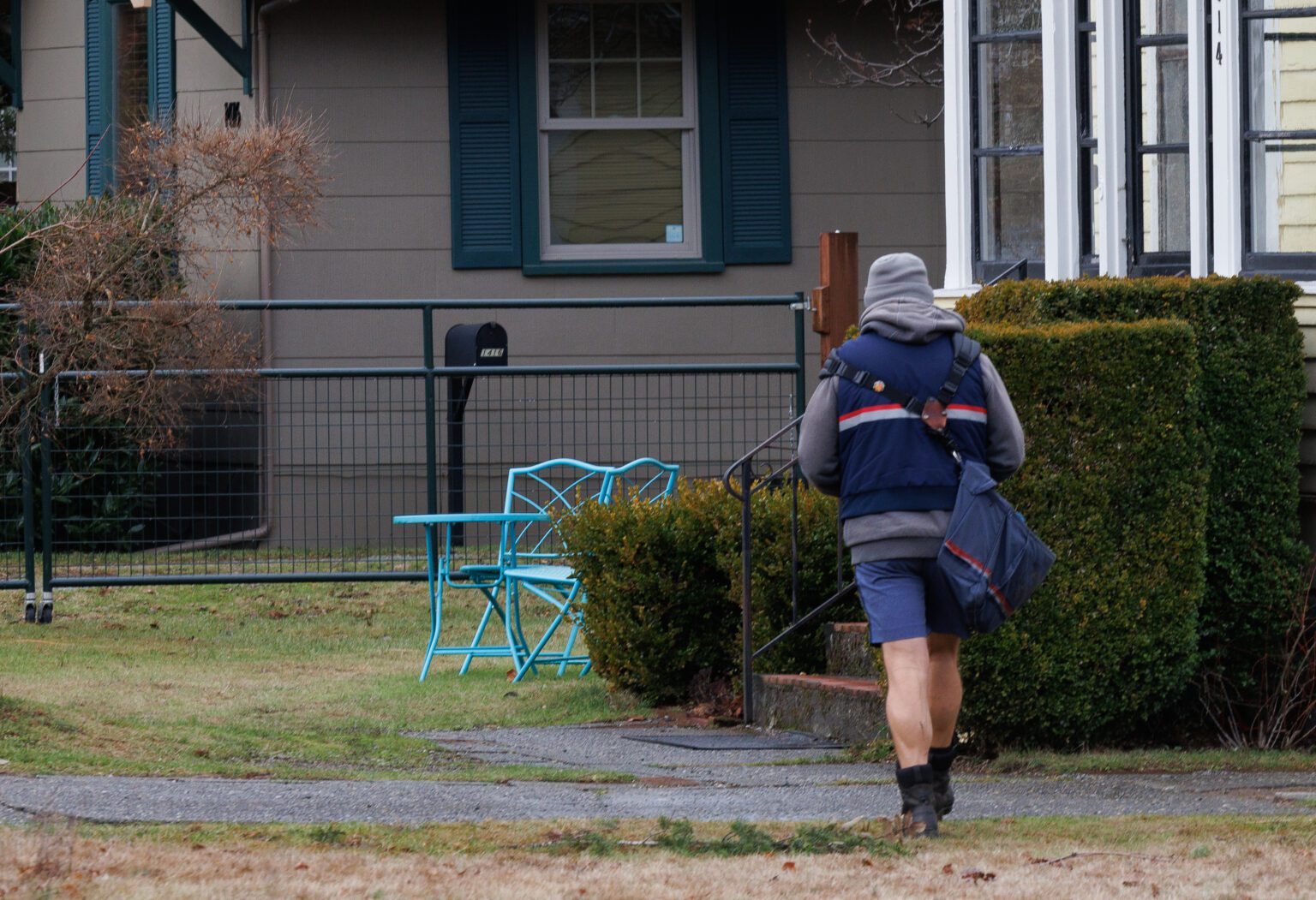 A postal worker walks door-to-door in the Columbia neighborhood delivering mail on Dec. 30