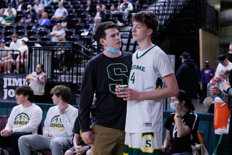 Sehome head coach Skyler Gillispie talks with Sehome's Grey Garrison after fouling out of the game as Sehome lost to Tumwater 67-42 in a consolation game at the 2A boys basketball championships at the Yakima Valley SunDome on March 4.