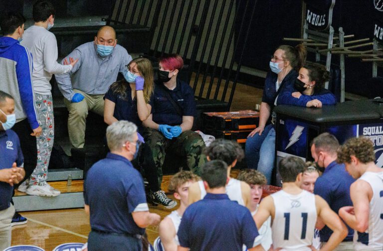 Students with the Squalicum High sports medicine program talk together during a break at a Squalicum boys basketball game on Dec. 13.