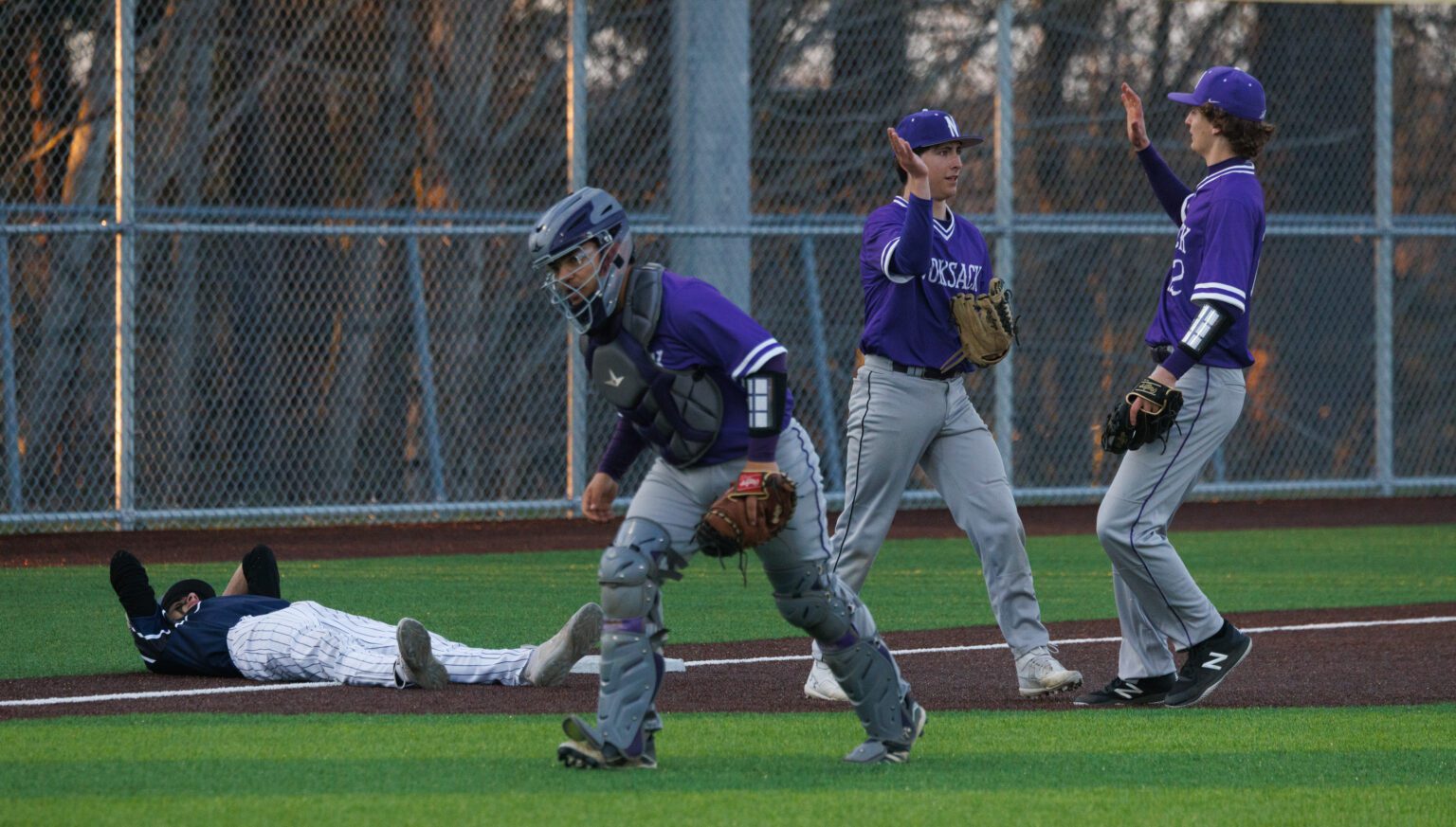 Nooksack Valley’s Matthew Blake and Bennett DeLange high-five April 12 after catching Squalicum’s Chase Anderson in a rundown at third base in the seventh inning. Nooksack Valley beat Squalicum 4-1 in Bellingham.