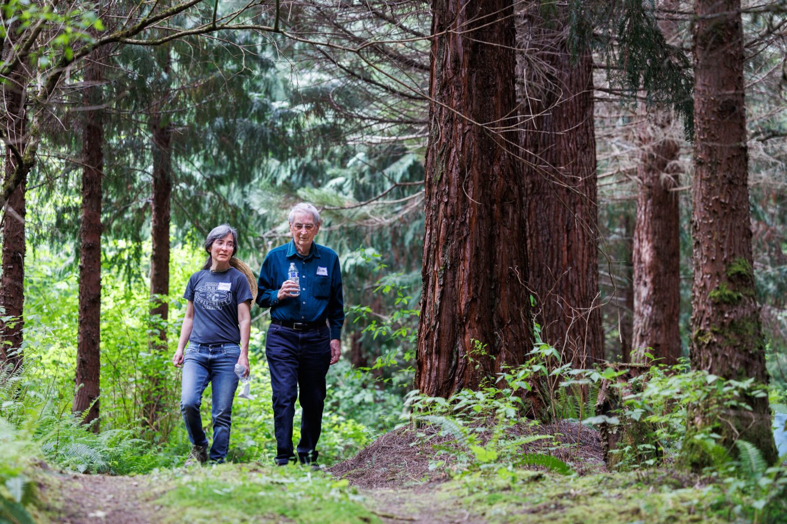 Bob Barker walks by sequoia trees at his tree farm with his daughter Robin on May 21. Bob Barker was named the 2022 Washington Tree Farmer of the Year.