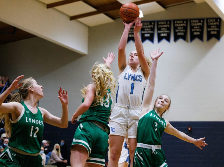Lynden Christian’s Libby Stump hits a jump shot over Lynden defenders as Lynden Christian beat Lynden 65-47 in a girls basketball game on Jan. 27.