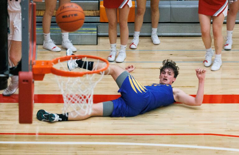 Ferndale's Mark Schlichting watches the ball bounce around the basket after being knocked down during a district boys basketball playoff game in Everett.