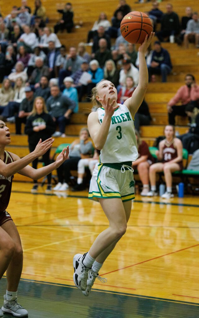 Lynden's Mya VanderYacht attempts for a layup as a defender reacts as she fails to reach her in time next to her.