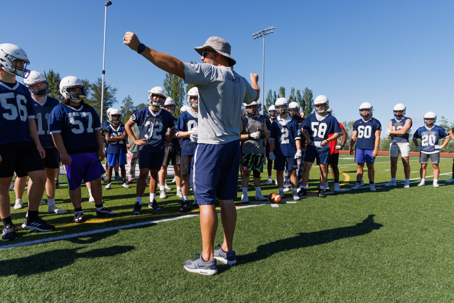Head coach Nick Lucey talks with the Squalicum High School football team at their practice on Aug. 17.