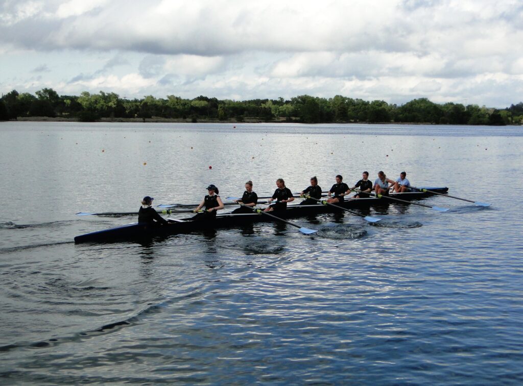 A team of rowers getting ready to start on the waters.