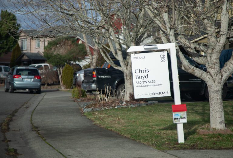 A "For Sale" sign is posted outside a home in the King Mountain neighborhood in January 2023.