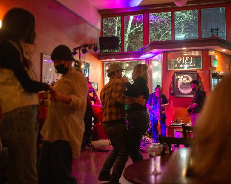People dance while Nuages performs Gypsy jazz at Uisce Irish Pub in Bellingham on Friday.