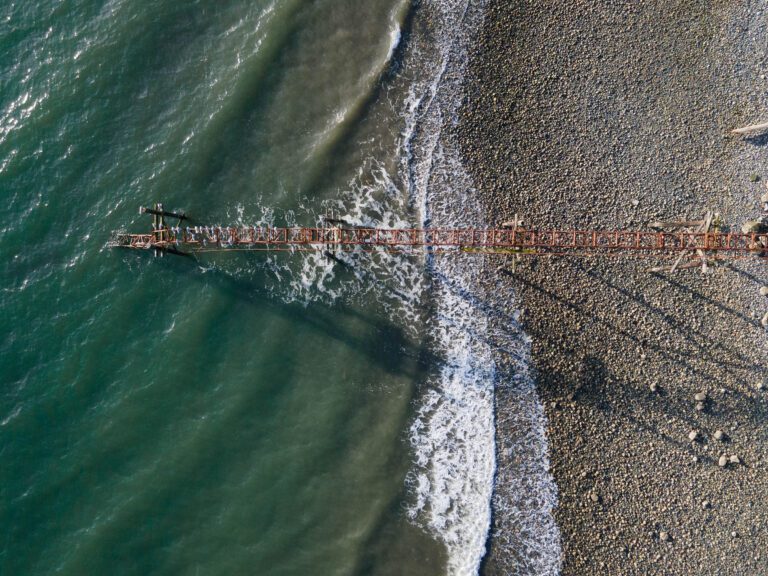 A derelict conveyor on the beach by Cherry Point stretches into the Georgia Strait.