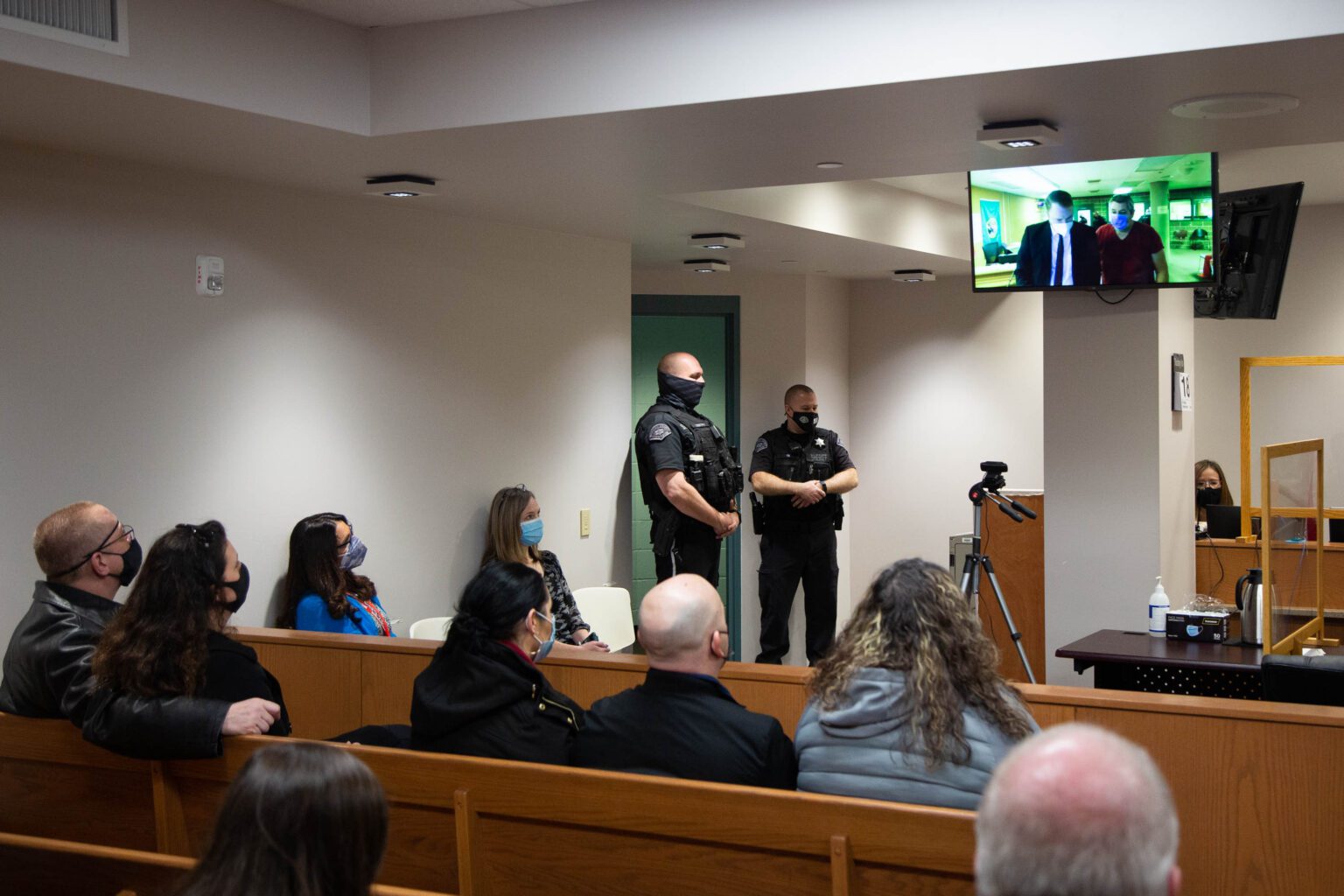Whatcom County deputies Jason Thompson and Ryan Rathbun watch the arraignment of Joel B. Young on Feb. 18.