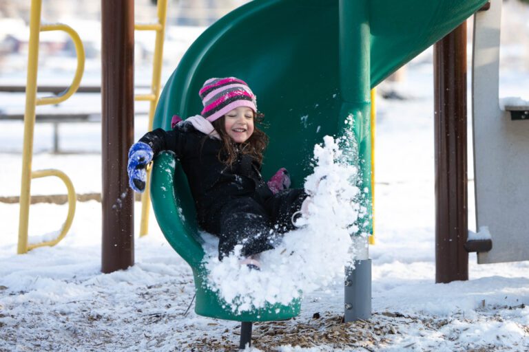 Alexis slides into a pile of snow at Bloedel Donovan Park on Feb. 24. Snow fell overnight