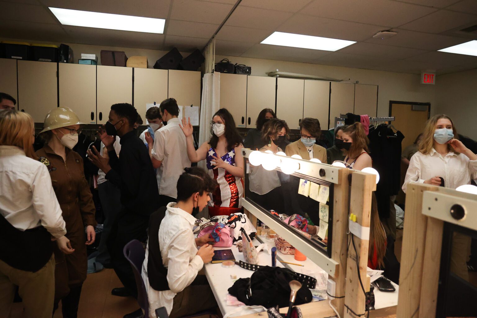 The joyful chaos of intermission unfolds with hair and makeup touch-ups