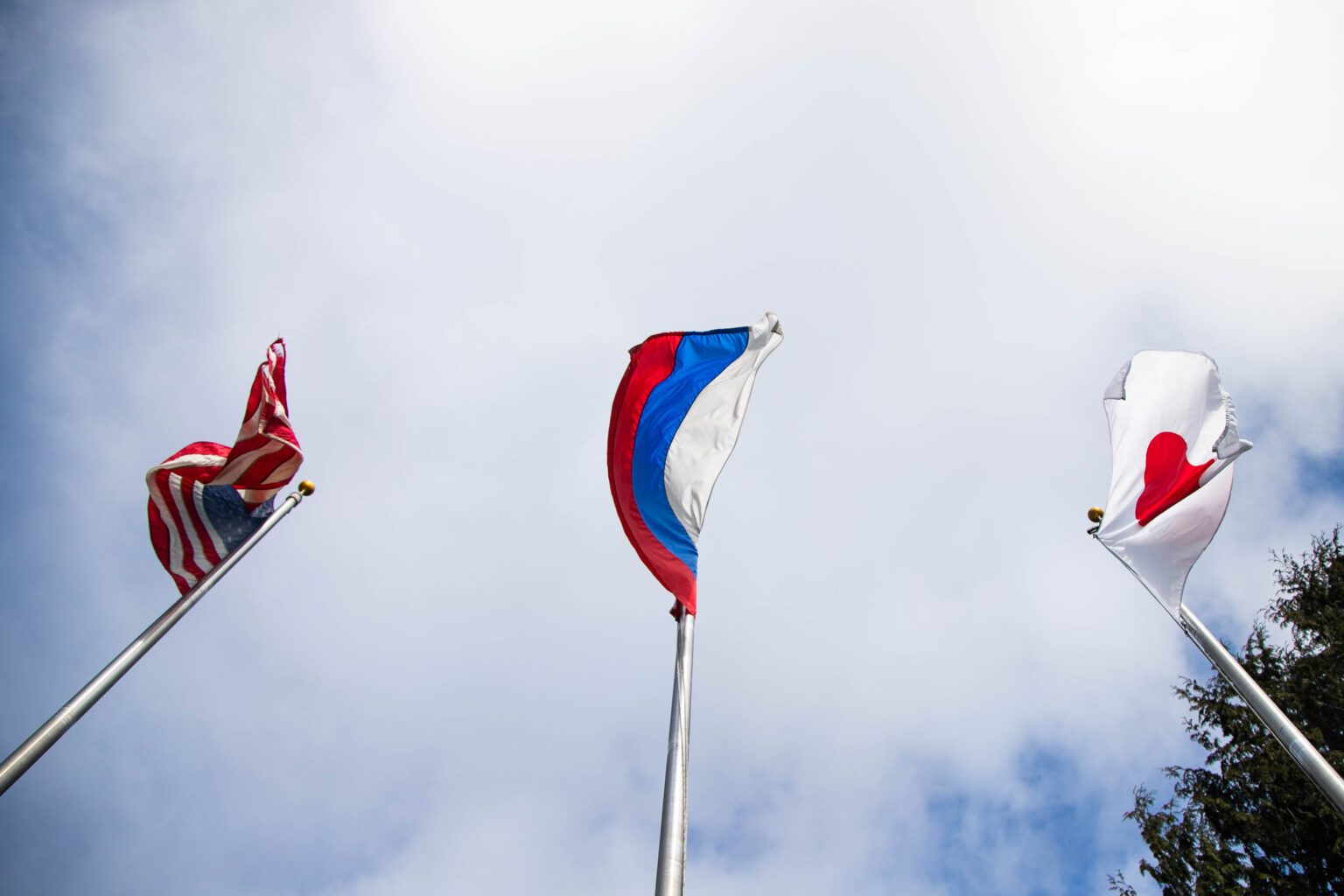 A Russian flag flies behind the Anacortes welcome sign on March 4