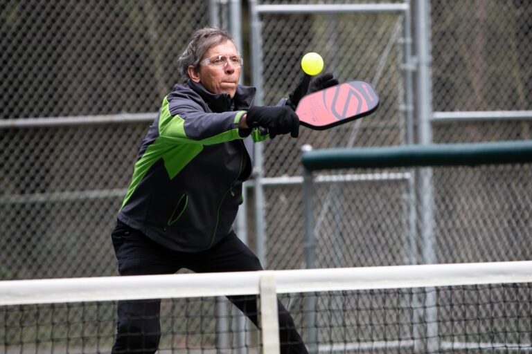 Paul Orlowski returns the ball across the court during a match of pickleball at Cornwall Park on March 7. Orlowski frequents the courts as much as four times a week.