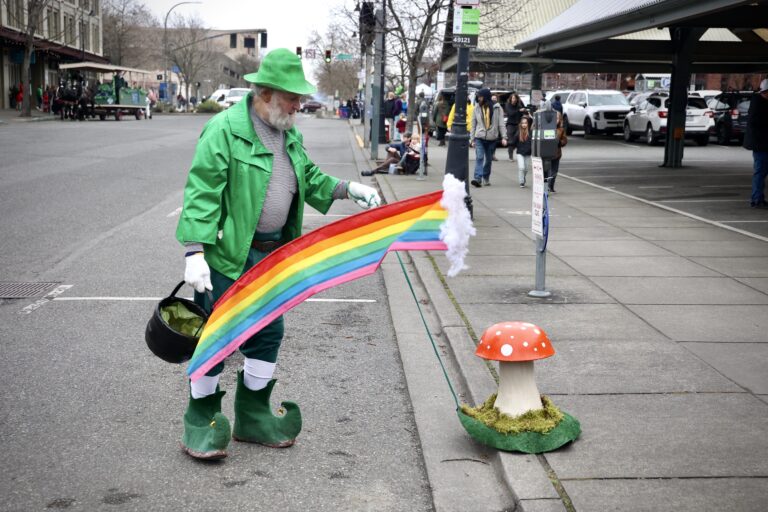 Lichen the Leprechaun found his pot of gold at the end of the rainbow. The golden chocolate coins that filled the pot were shared with parade-goers.