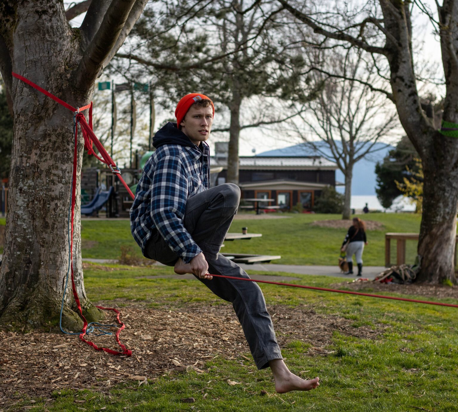 Chandler Johnston prepares to lift himself onto his slackline at Boulevard Park on April 14. Johnston has only been slacklining for a few months and can balance and walk the slackline.