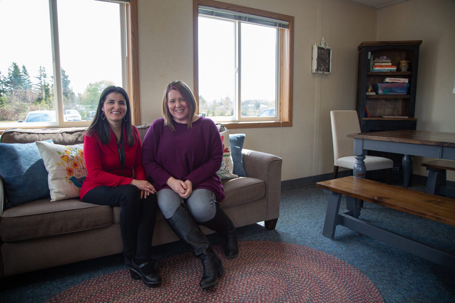 Cultural liaison Elvira Rozen and family services coordinator Alicia Roberts sit on the couch in Meridian School District's new Family Resource Center at Irene Reither Elementary School on April 25.