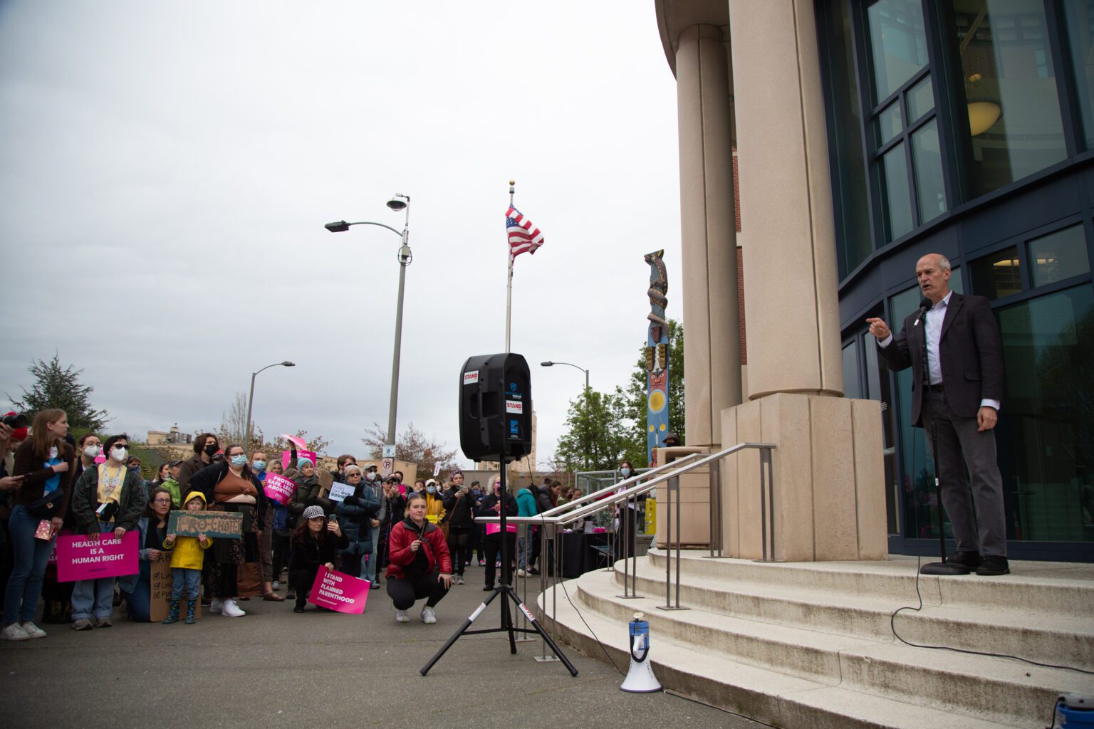 U.S. Rep. Rick Larsen speaks in front of the Whatcom County Courthouse as a crowd listens.