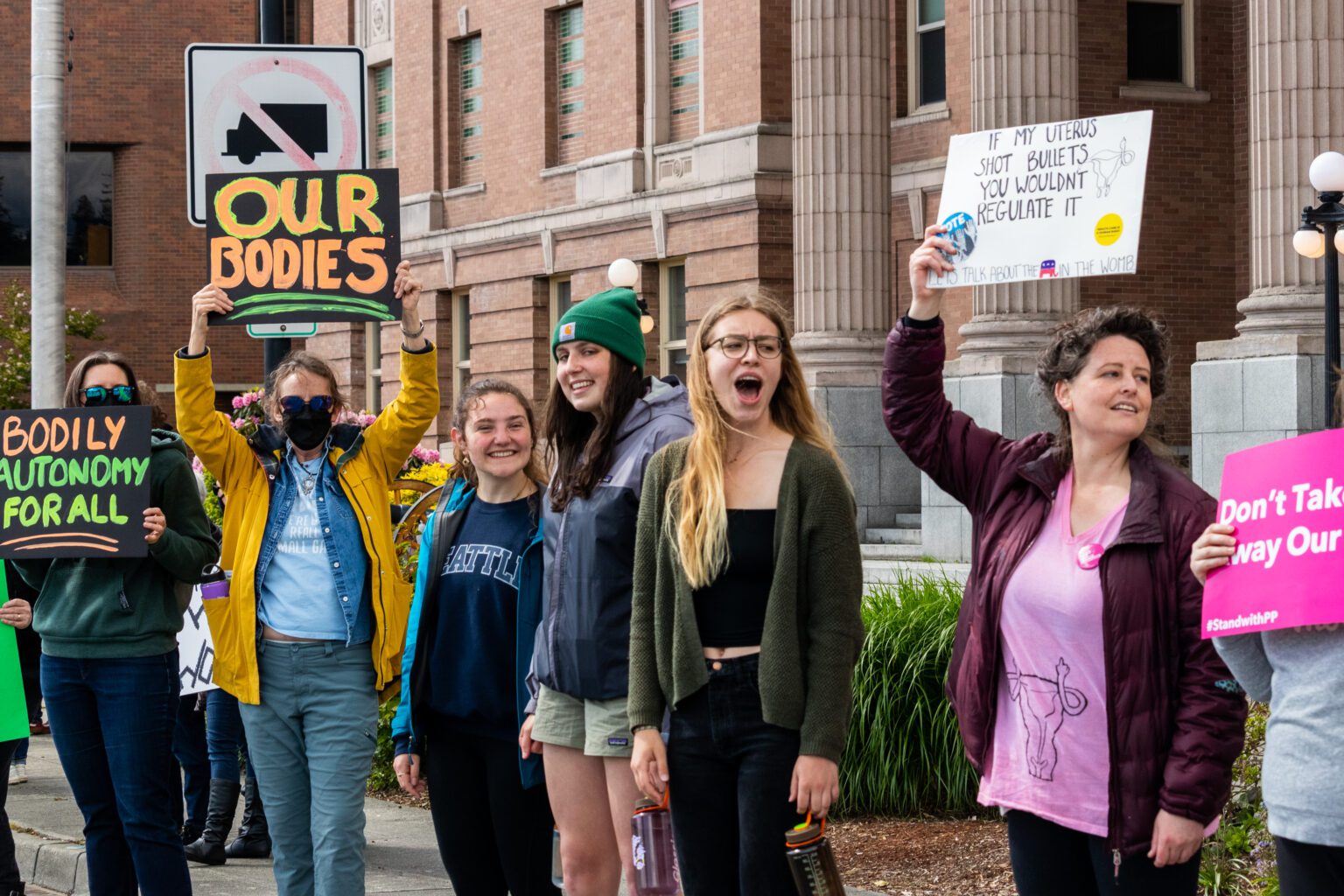 Reproductive rights protesters wave their signs at passing cars during the The Bans Off Our Bodies rally at the Skagit County Superior Courthouse in Mount Vernon on May 14.