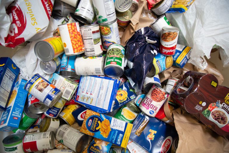 Cans, boxes of food, and other non-perishable food stewn on the floor.