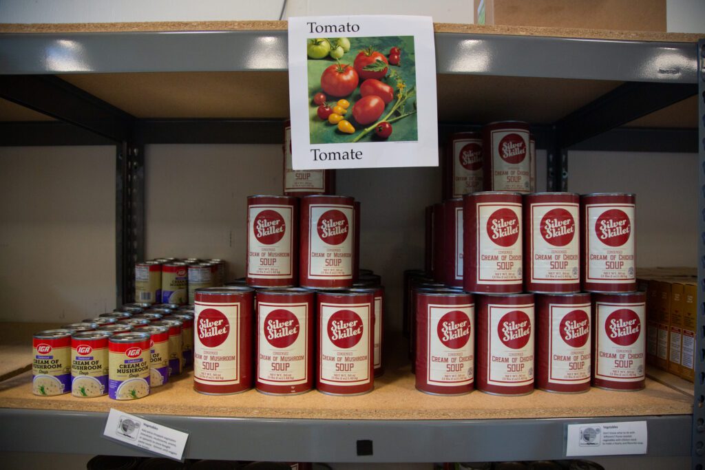 Cans of various types of canned soup stacked on the shelves.