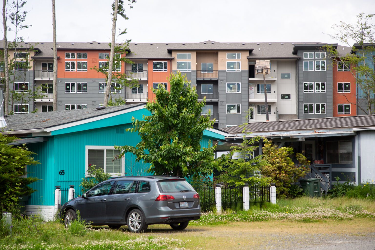 A new apartment complex looms behind the Bakerview Estates mobile home park near Bellis Fair. Bellingham is developing rules to protect manufactured home parks.