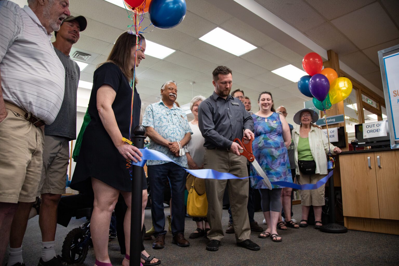 Branch manager Paul Fullner cuts the ribbon celebrating the renovation of the Everson McBeath Community Library on June 27. The new building features new custom shelves for the books