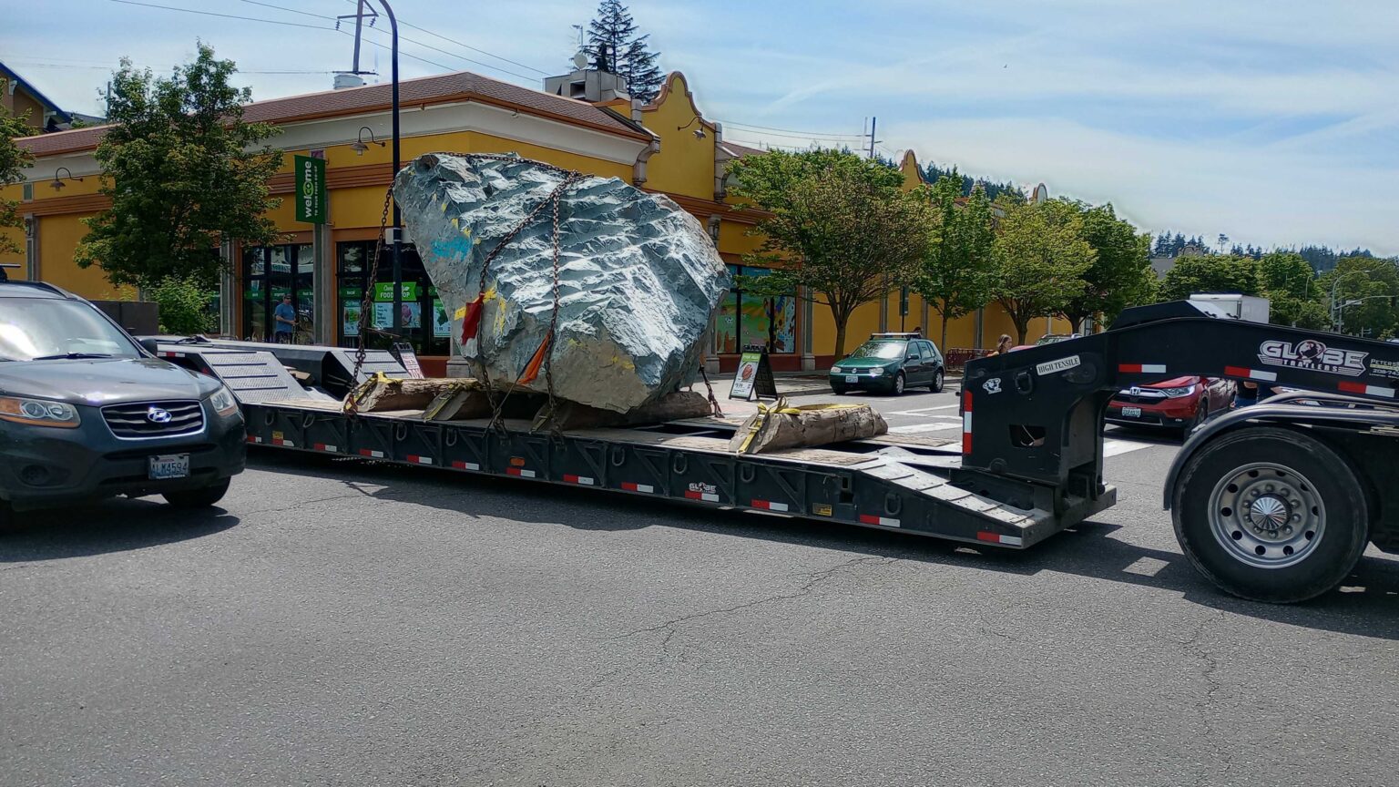 A tractor-trailer hauls a large basalt boulder through downtown Bellingham in June. This unusual cargo has been a regular sight on city streets over the past several months.