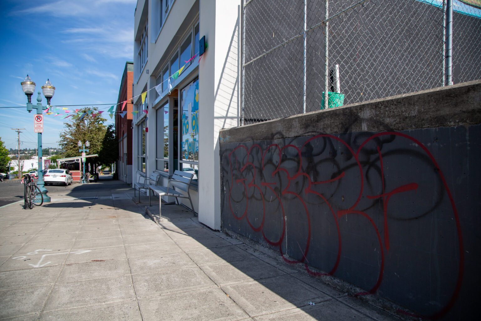 Red and black graffiti cover a wall on Holly Street in Bellingham. Vandalism and property destruction were a common concern among businesses surveyed by the Bellingham Regional Chamber of Commerce.
