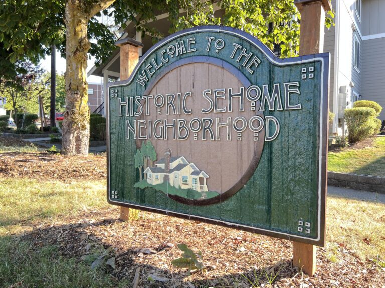 A sign on the corner of Ellis and Chestnut streets welcomes travelers to Bellingham's Sehome neighborhood. As a place name