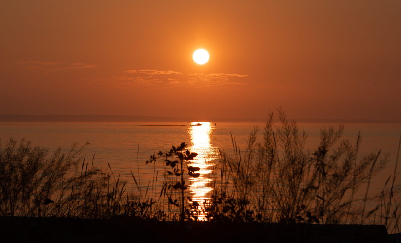 The sun sets a blazing orange from residual wildfire smoke as seen from the Semiahmoo shore on Sept. 12.