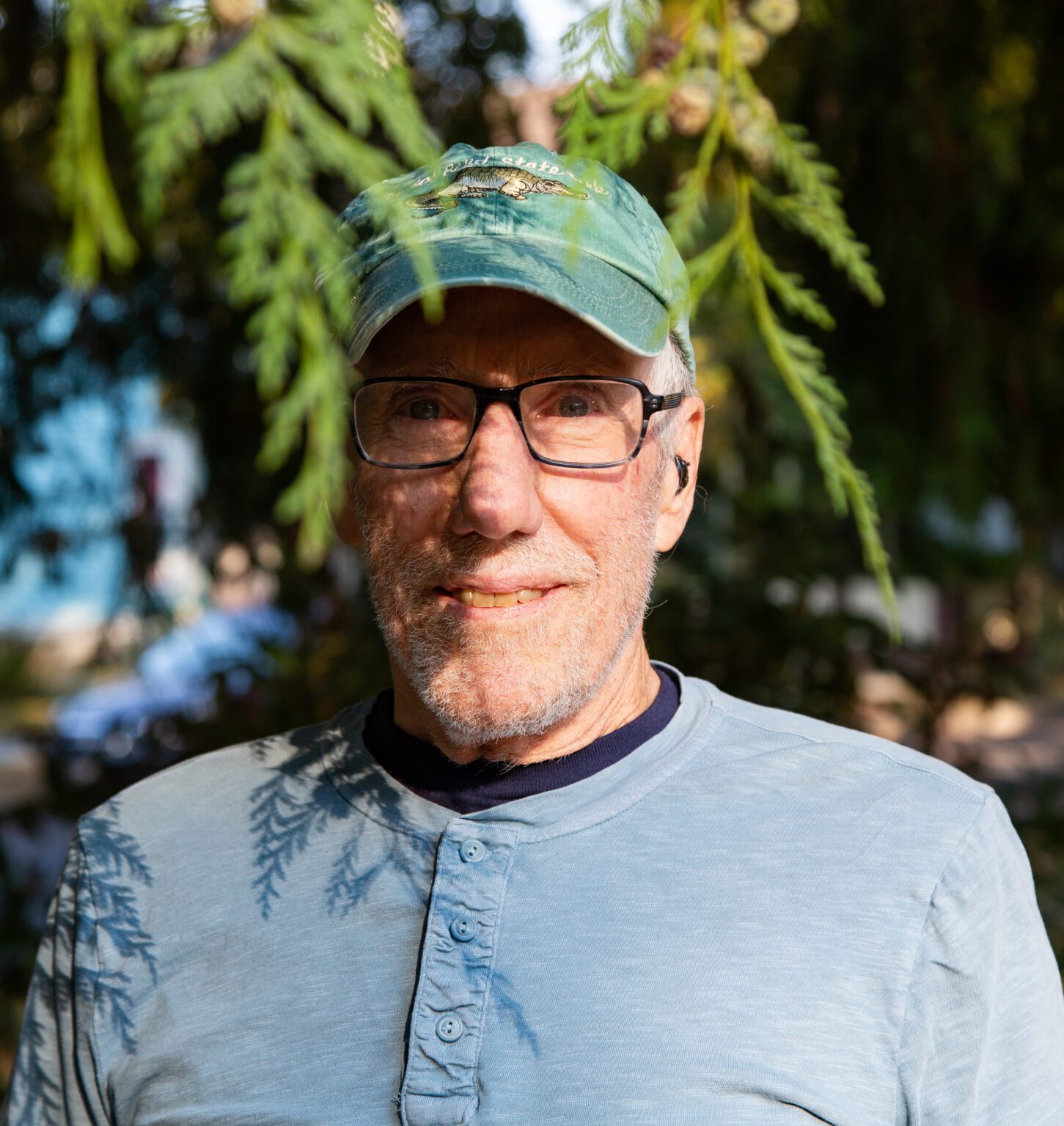 John Wesselink stands in the shadow of a Port Orford cedar tree at Elizabeth Park on Sept. 27. Wesselink maps trees and their taxonomies throughout Bellingham. He was first inspired to map out Elizabeth Park after spending years walking through as a mail carrier for the U.S. Postal Service.