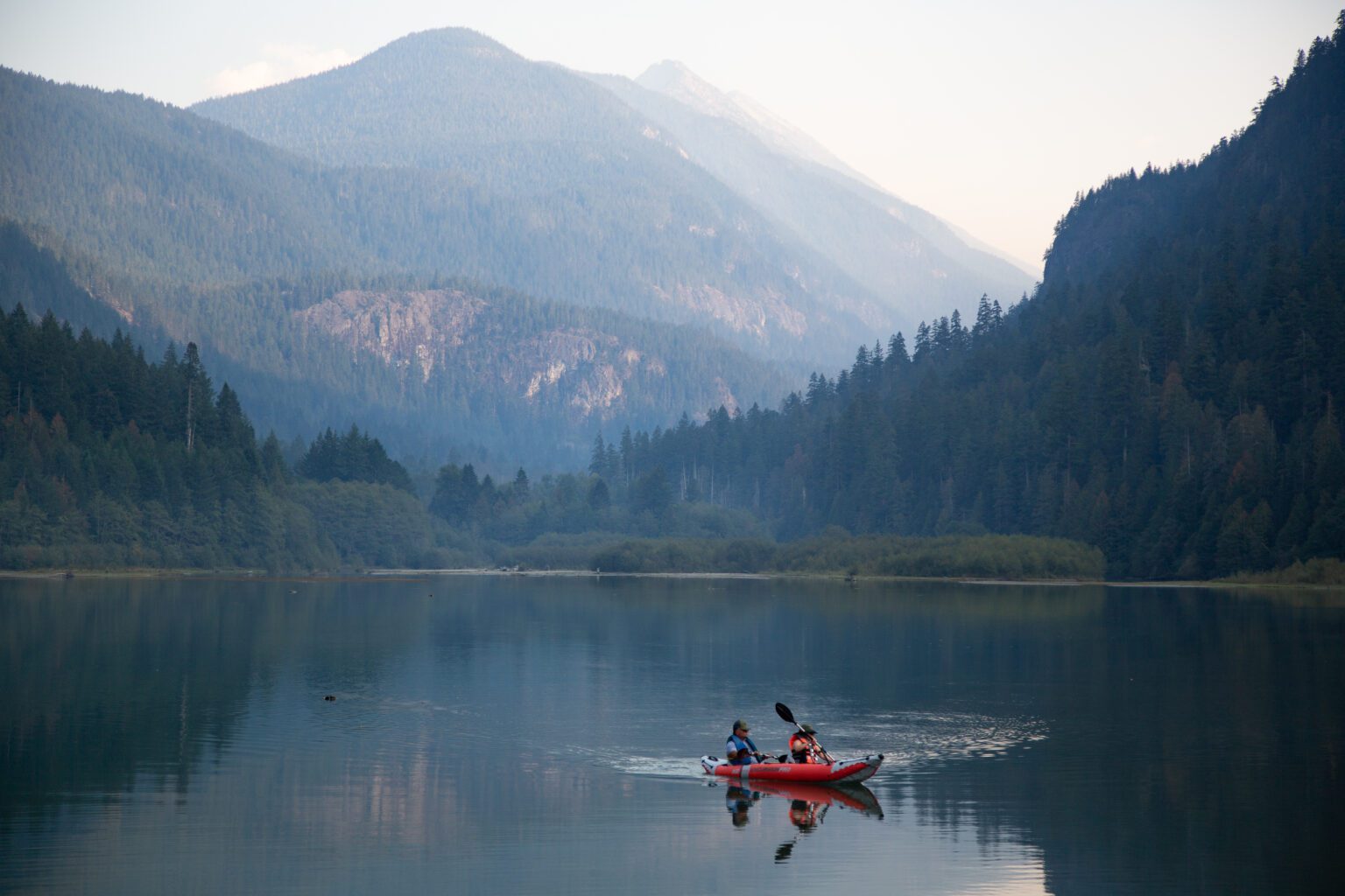 Kayakers glide through the waters of Diablo Lake in North Cascades National Park in October 2022. The park will receive significant grant funding for projects related to bear safety education