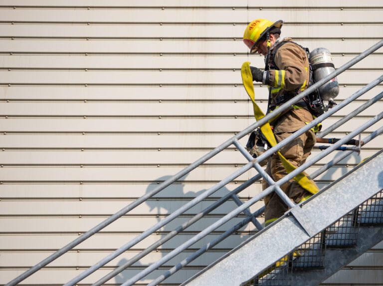 A Bellingham Fire Academy cadet runs down stairs in October 2022 during training. Overtime for the Bellingham Fire Department was about $1.8 million over budget in 2021 and 2022.