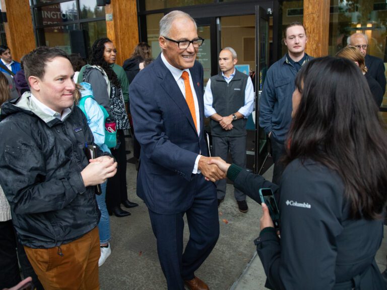 Gov. Jay Inslee shakes hands with audience members at the end of a press conference at Western Washington University in October 2022. Inslee signed a bill into law May 9 that protects young people seeking reproductive health services or gender-affirming care.