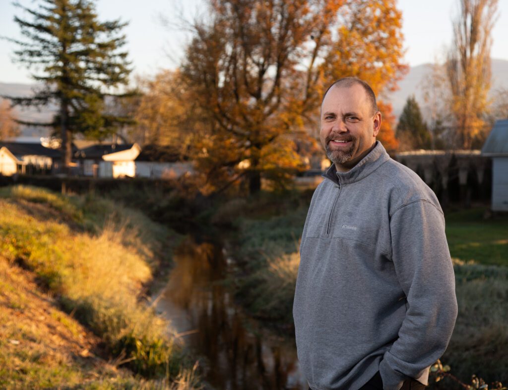 Former Sumas mayor Kyle Christensen stands by a creek.