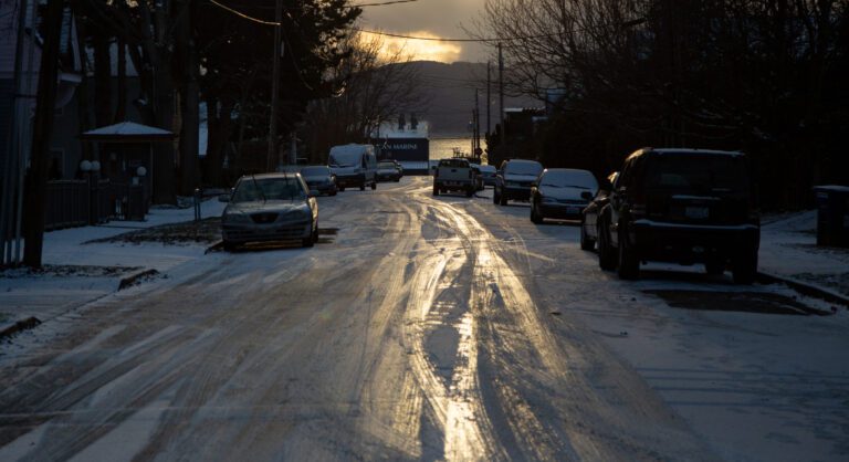 The sunset illuminates an icy H Street on Dec 18. Snow continues to fall on Bellingham.
