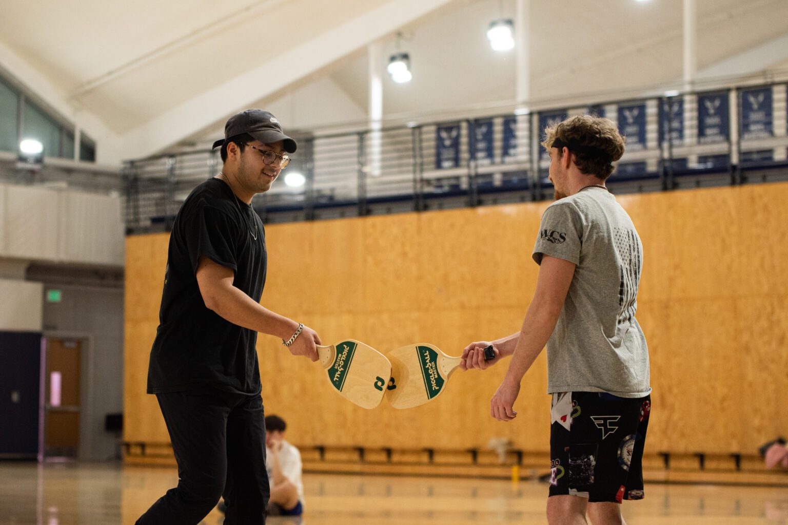 Western Washington University students Tyler Brill and Yosmith Hernandez slap paddles after scoring a point during a pickleball game at Carver Gymnasium on the Western Washington University campus Jan. 22.