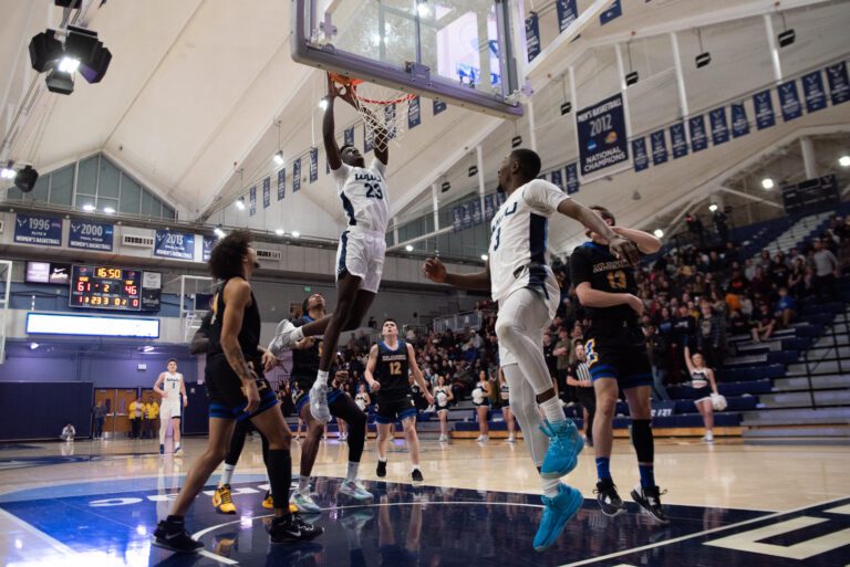 Western redshirt freshman forward BJ Kolly (23) hovers above the rim Feb. 9 before slamming down an alley-oop from senior guard Daniel Hornbuckle (3) in an 87-80 win over Alaska Anchorage.