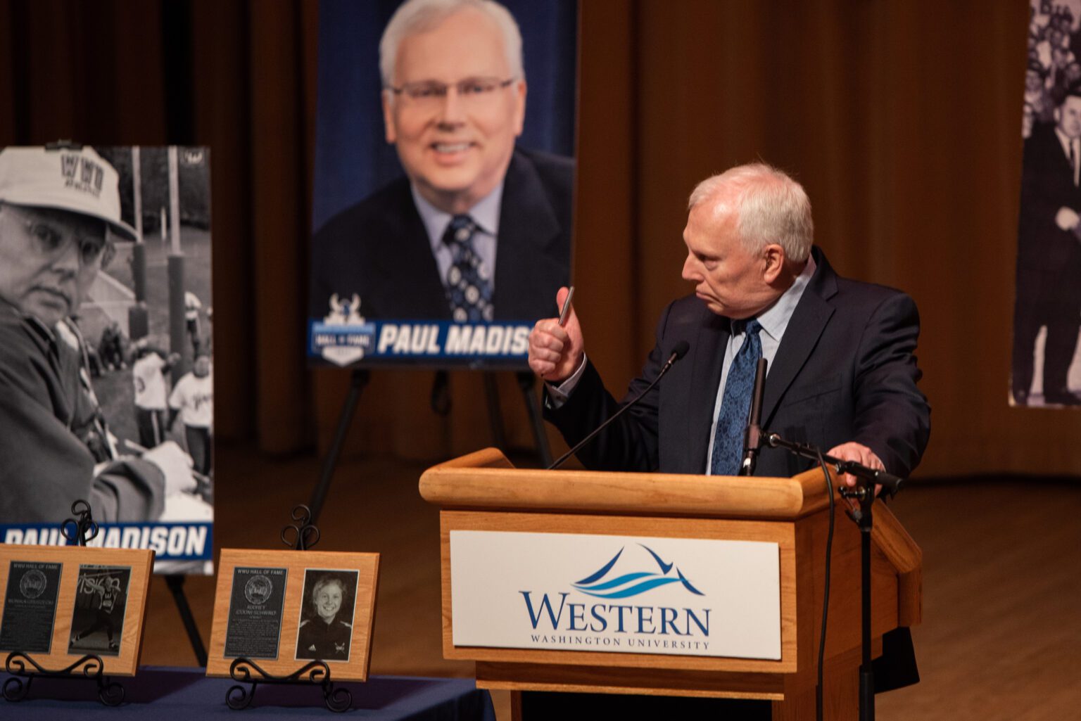 Paul Madison gives a thumbs up on Feb. 11 while addressing the audience at Western Washington University Athletics' 2023 Hall of Fame induction ceremony. Madison spent 48 years as Western's sports information director. After retiring in 2015